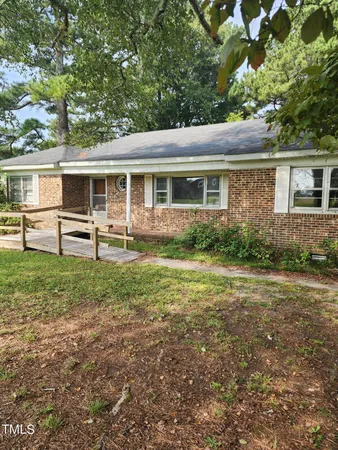 a view of a house with yard and a garden