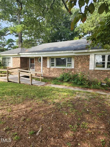 a view of a house with yard and a garden