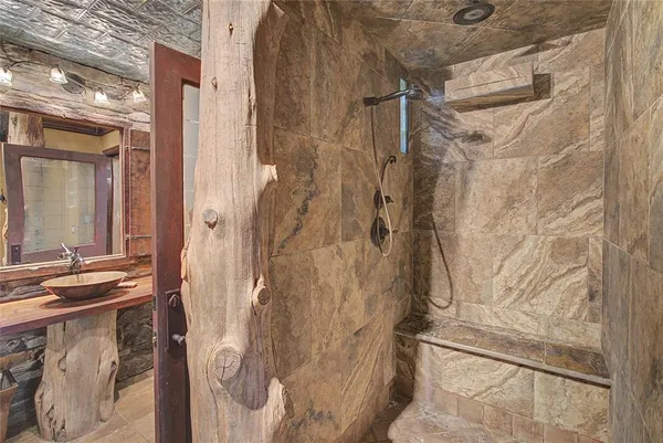 a bathroom with a shower and a sink
