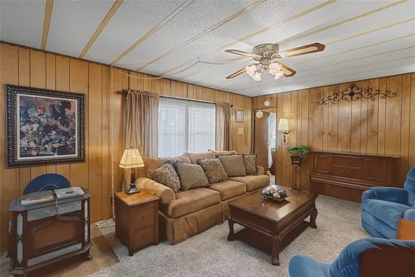 a living room with furniture and a chandelier