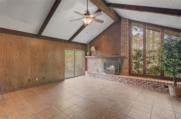 a view of a livingroom with a fireplace and a ceiling fan