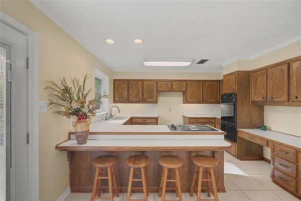 a kitchen with stainless steel appliances granite countertop a sink and a refrigerator
