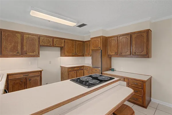 a kitchen with a stove and a refrigerator