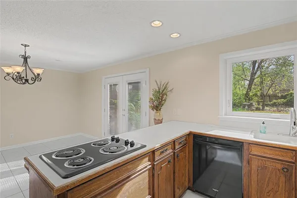a white kitchen with a stove and a sink