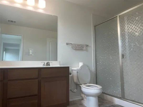 a bathroom with a sink mirror toilet and a shower