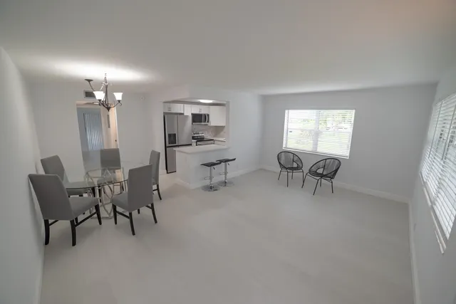 a room with gym equipment and view of living room