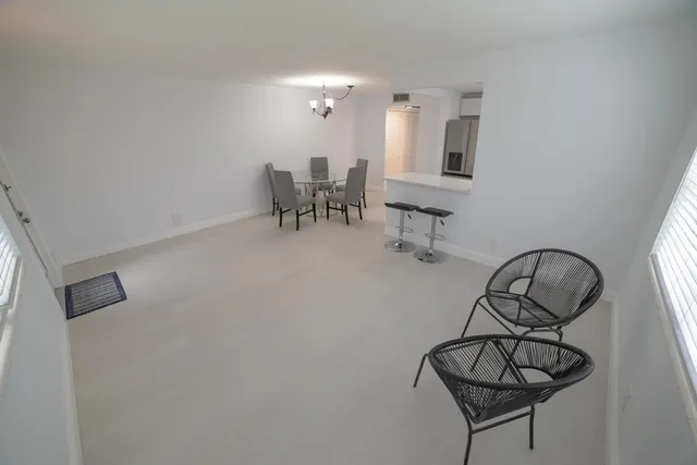 a view of a dining room with furniture and a chandelier