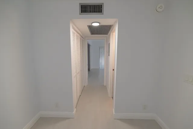 a bathroom with a granite countertop toilet sink mirror and vanity