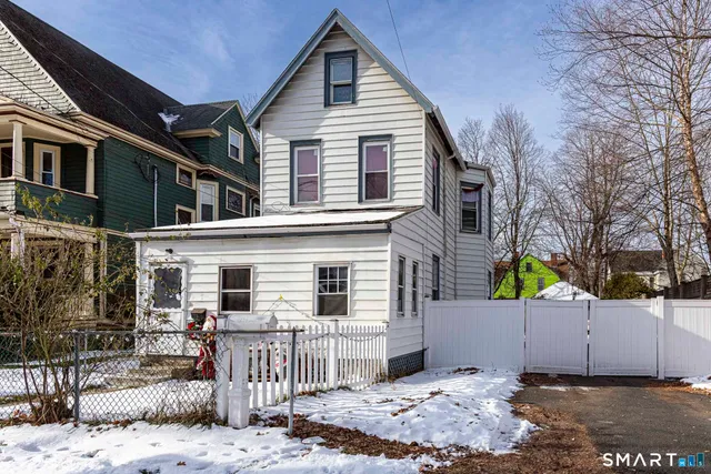 a view of a house with a wooden fence
