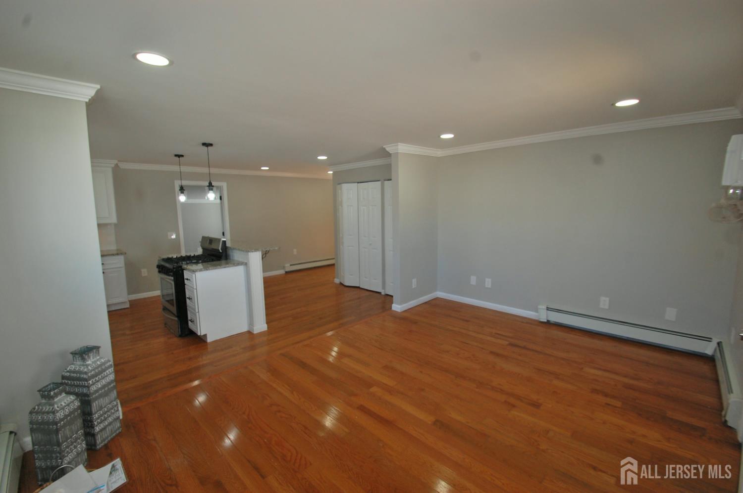 807 6th Street Union Beach, NJ 07735 - Photo 11 of 44 a big room with wooden floor and a kitchen