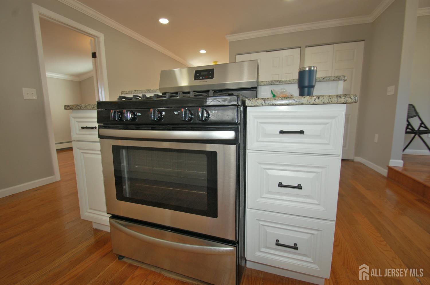 807 6th Street Union Beach, NJ 07735 - Photo 12 of 44 a kitchen with stainless steel appliances granite countertop a stove and a refrigerator