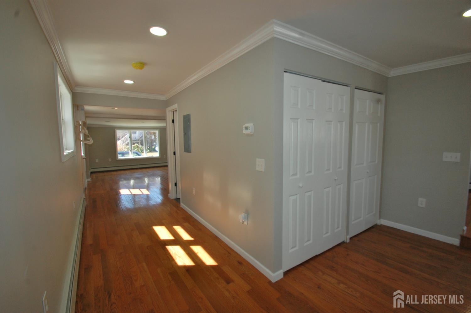 807 6th Street Union Beach, NJ 07735 - Photo 14 of 44 a view of an empty room and wooden floor and a window