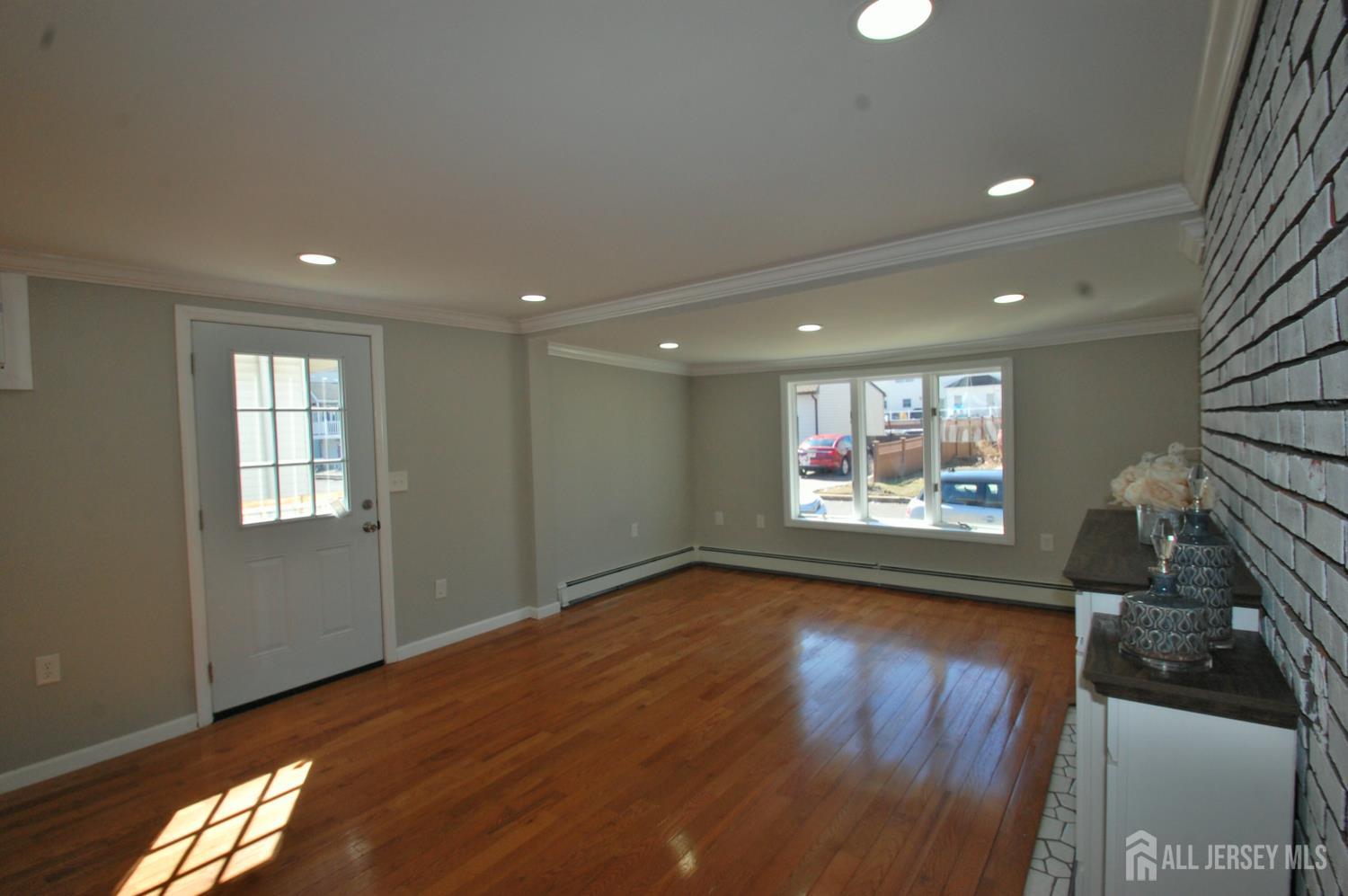 807 6th Street Union Beach, NJ 07735 - Photo 17 of 44 a view of room with window and wooden floor