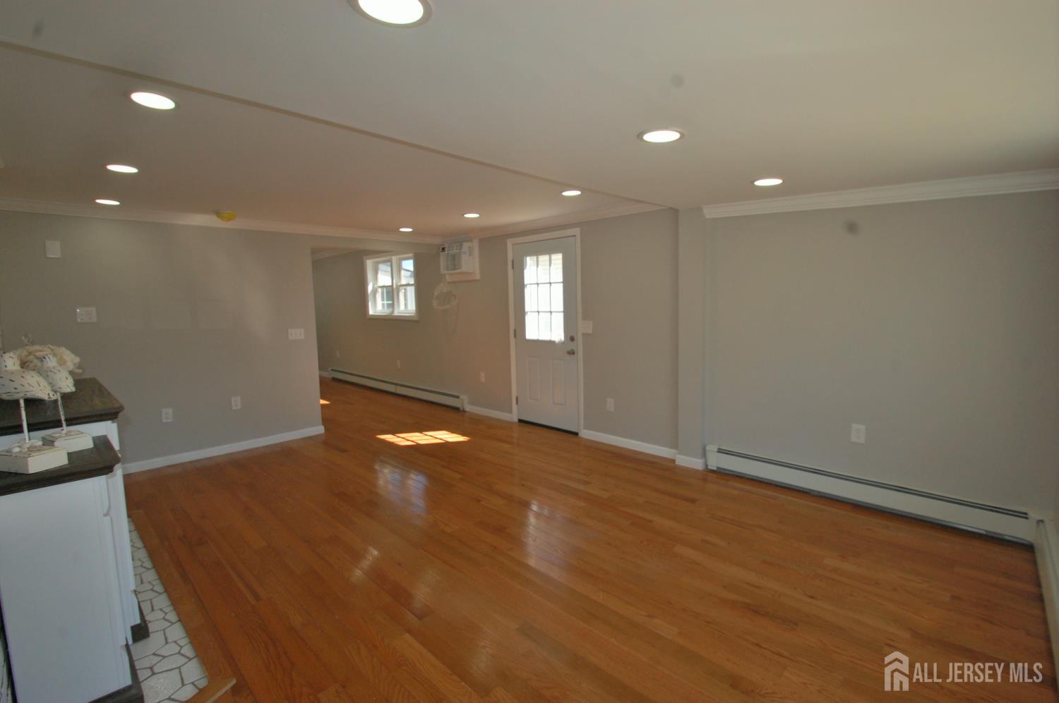 807 6th Street Union Beach, NJ 07735 - Photo 19 of 44 a view of an empty room with window and wooden floor