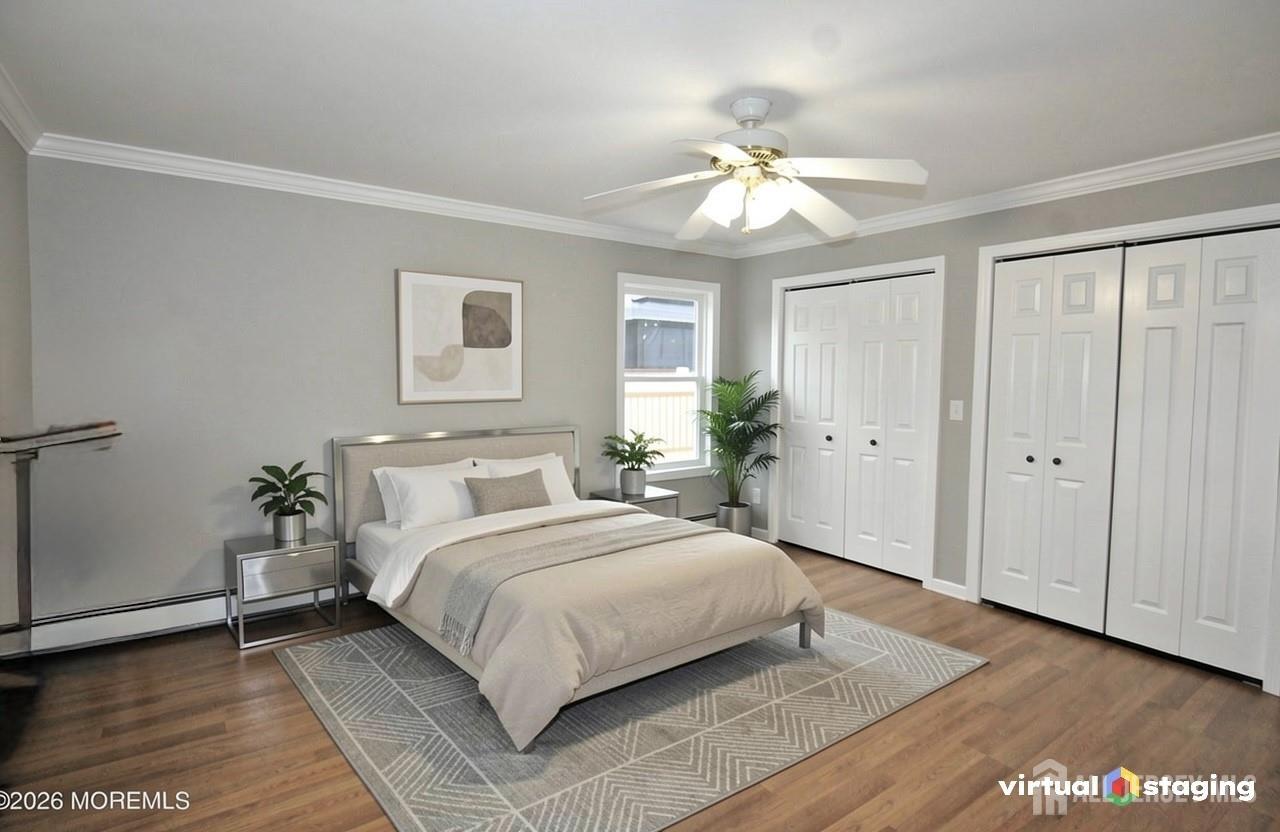807 6th Street Union Beach, NJ 07735 - Photo 20 of 44 a bedroom with a large bed chandelier and a window