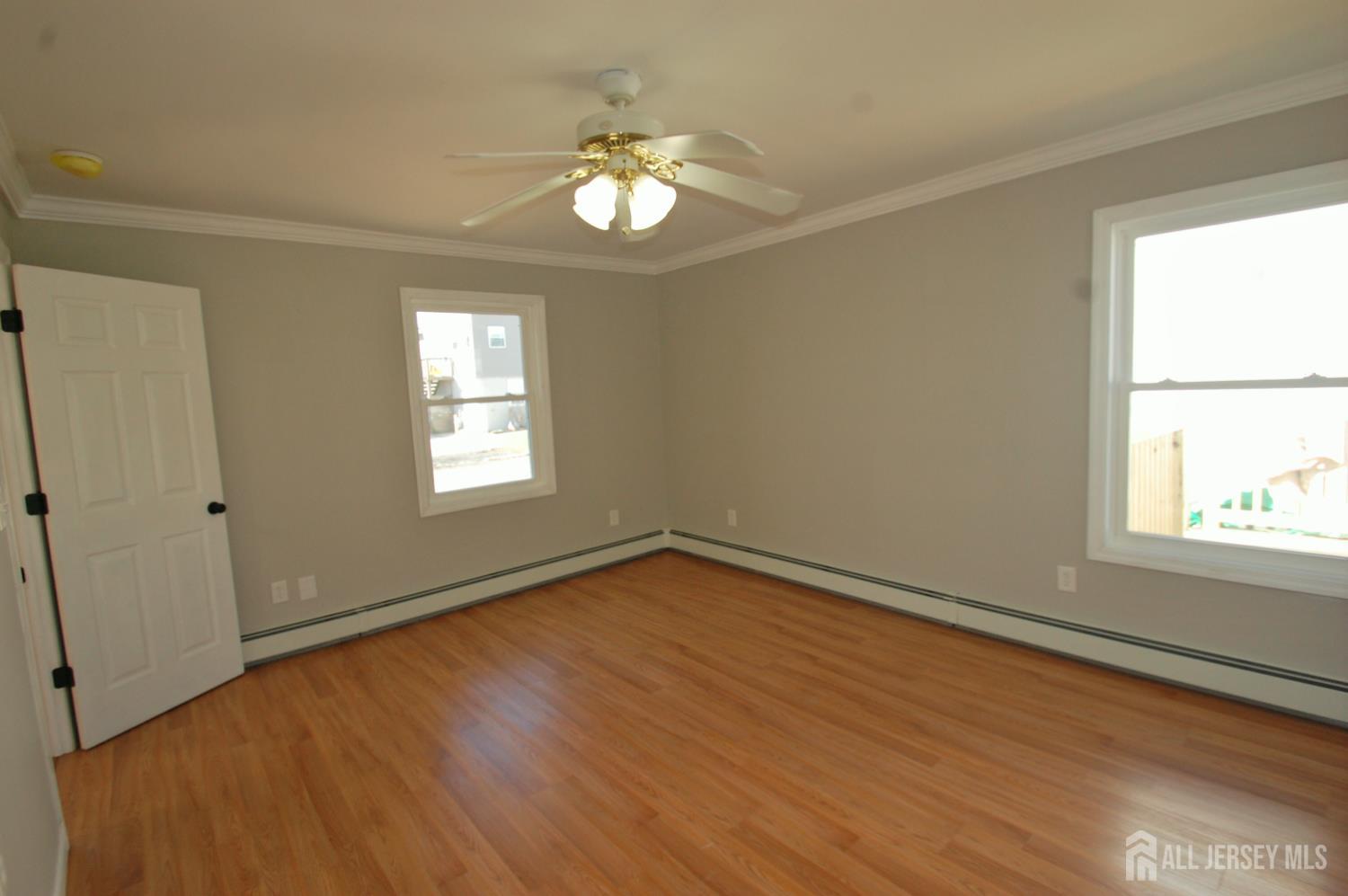 807 6th Street Union Beach, NJ 07735 - Photo 23 of 44 a view of an empty room with wooden floor and a window