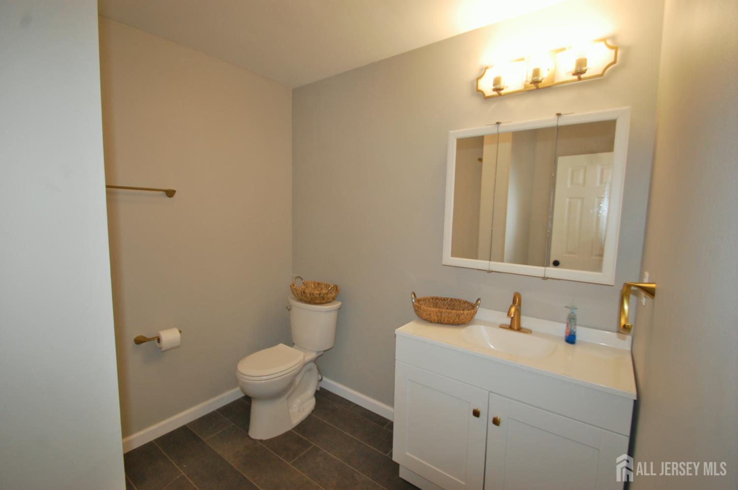 807 6th Street Union Beach, NJ 07735 - Photo 26 of 44 a bathroom with a sink and a mirror