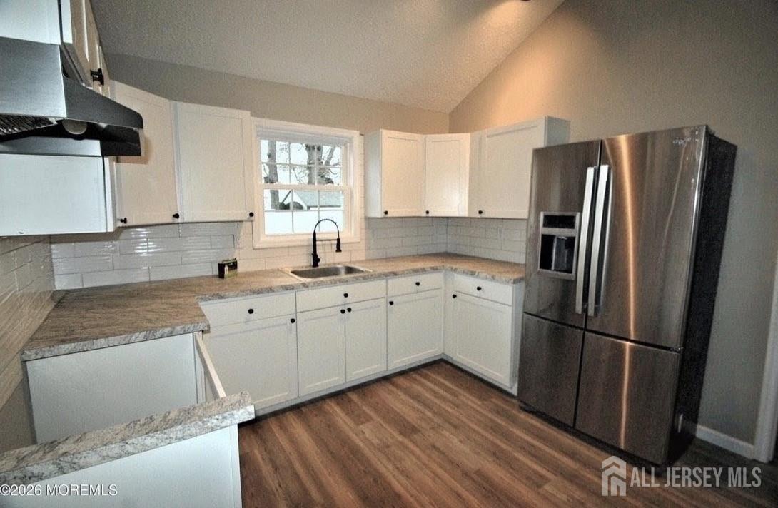 807 6th Street Union Beach, NJ 07735 - Photo 31 of 44 a kitchen with wooden cabinets and a refrigerator