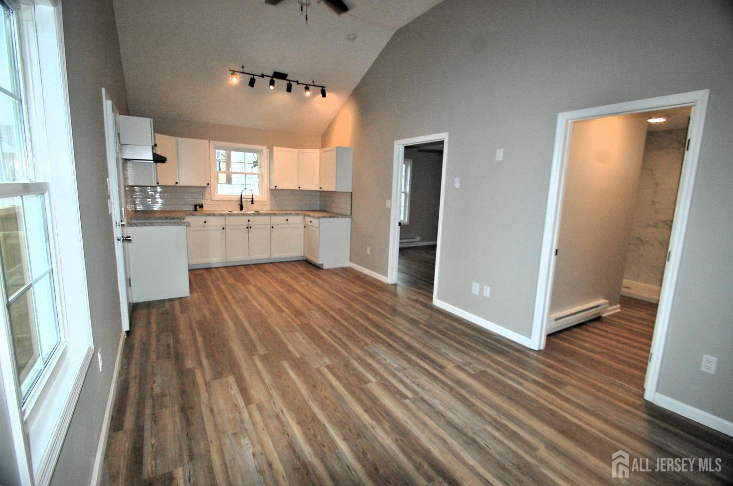 807 6th Street Union Beach, NJ 07735 - Photo 33 of 44 a kitchen with white cabinets and wooden floor