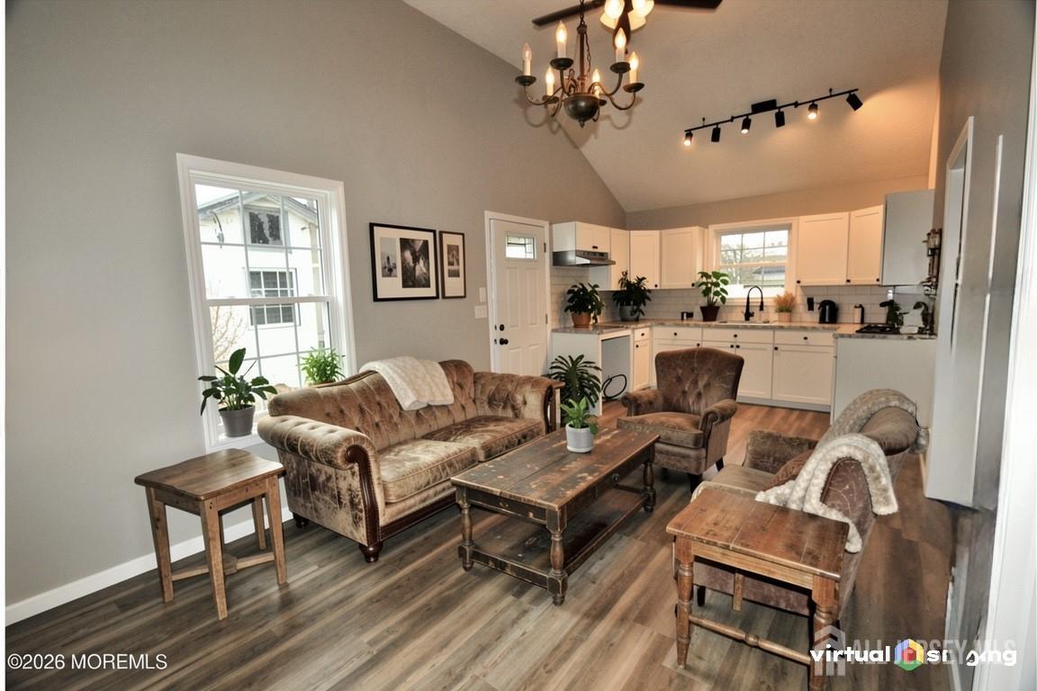 807 6th Street Union Beach, NJ 07735 - Photo 34 of 44 a living room with furniture a chandelier and a window