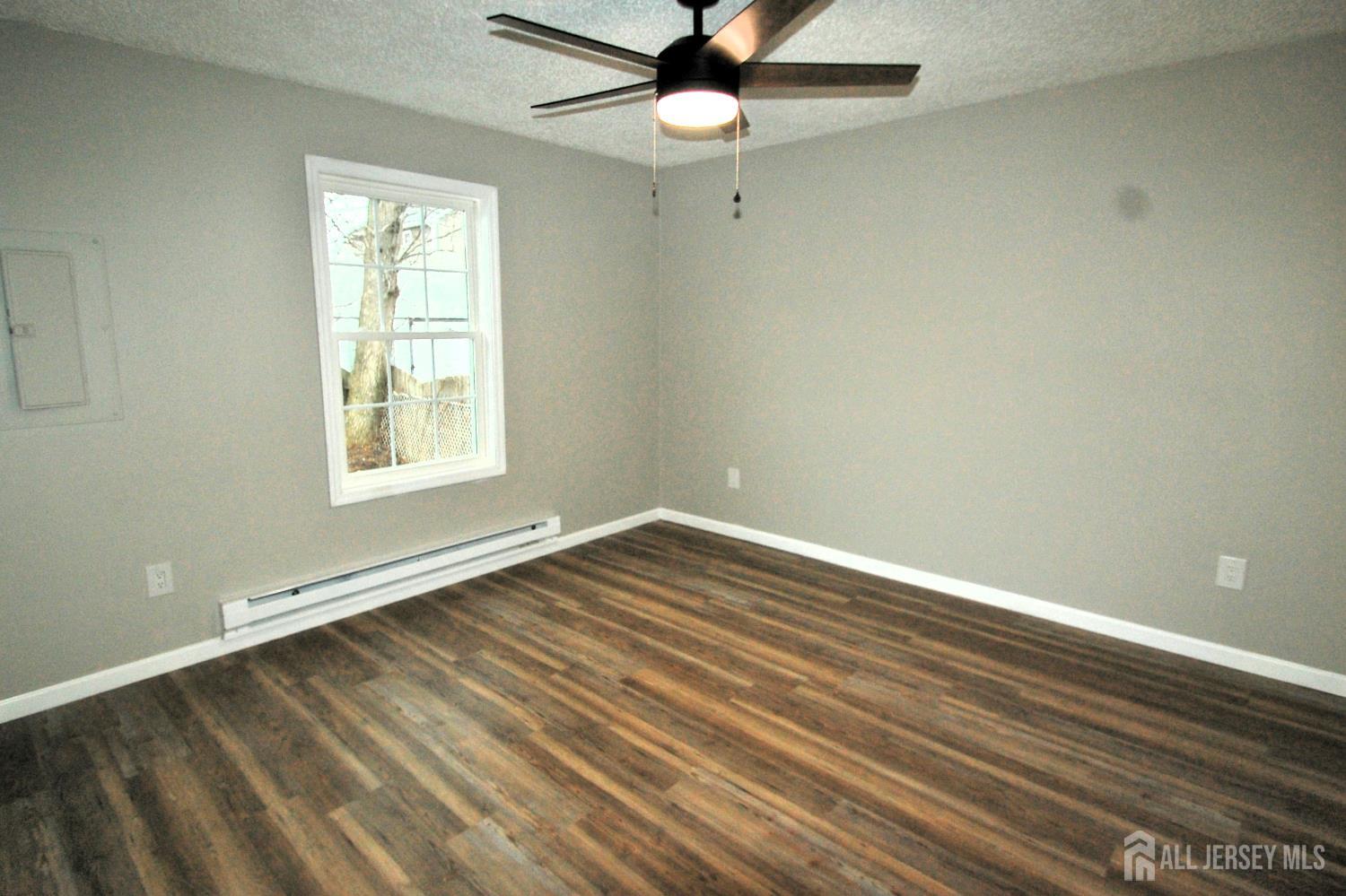 807 6th Street Union Beach, NJ 07735 - Photo 37 of 44 wooden floor in an empty room with a window