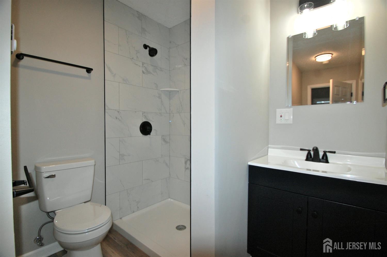 807 6th Street Union Beach, NJ 07735 - Photo 39 of 44 a bathroom with a sink a toilet and shower