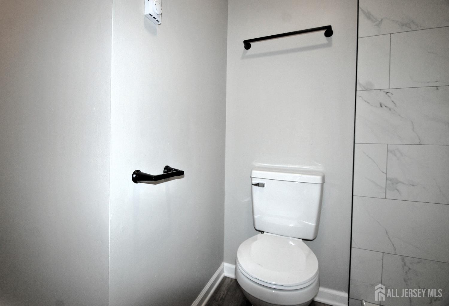 807 6th Street Union Beach, NJ 07735 - Photo 40 of 44 a white toilet sitting next to a shower