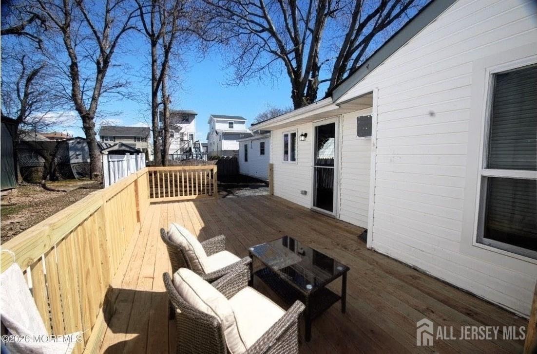 807 6th Street Union Beach, NJ 07735 - Photo 4 of 44 a backyard of a house with wooden floor and outdoor seating