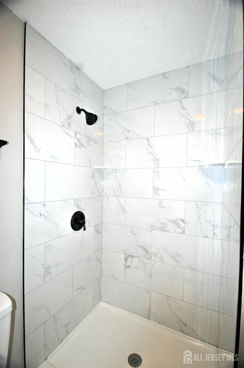 807 6th Street Union Beach, NJ 07735 - Photo 41 of 44 a bathroom with a shower