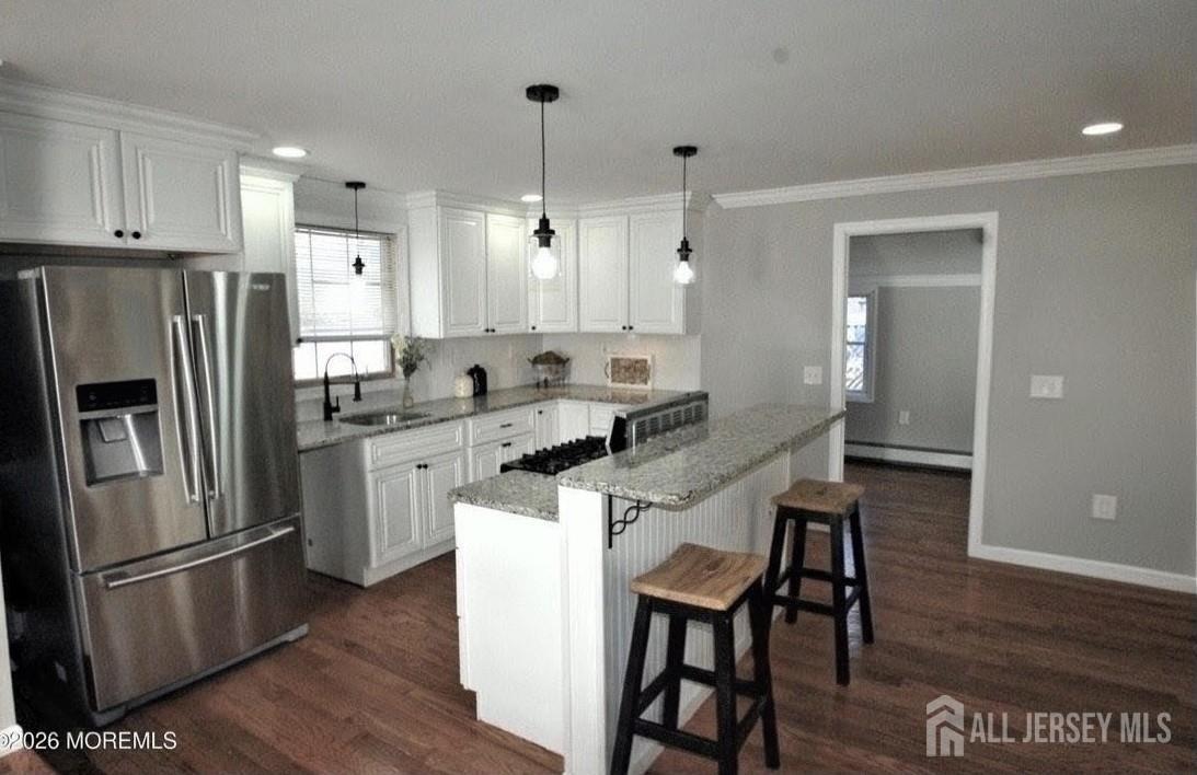 807 6th Street Union Beach, NJ 07735 - Photo 8 of 44 a kitchen with a refrigerator a sink dishwasher and a stove with wooden floor