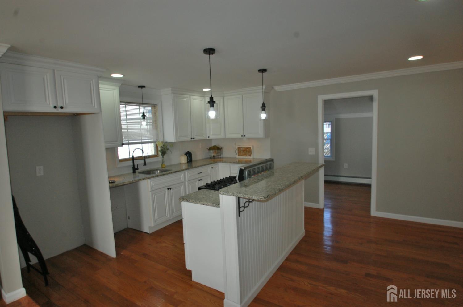 807 6th Street Union Beach, NJ 07735 - Photo 9 of 44 a kitchen with white cabinets and sink