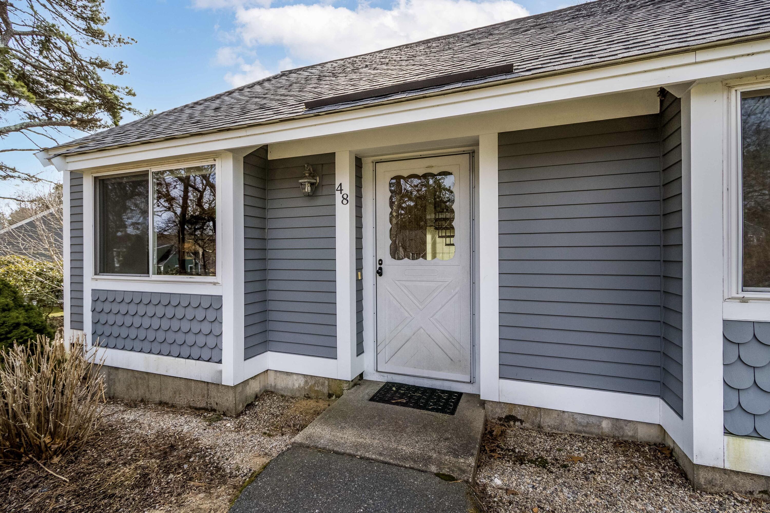 48 Middlecott Lane, Unit 48 Brewster, MA 02631 - Photo 1 of 36 a front view of a house