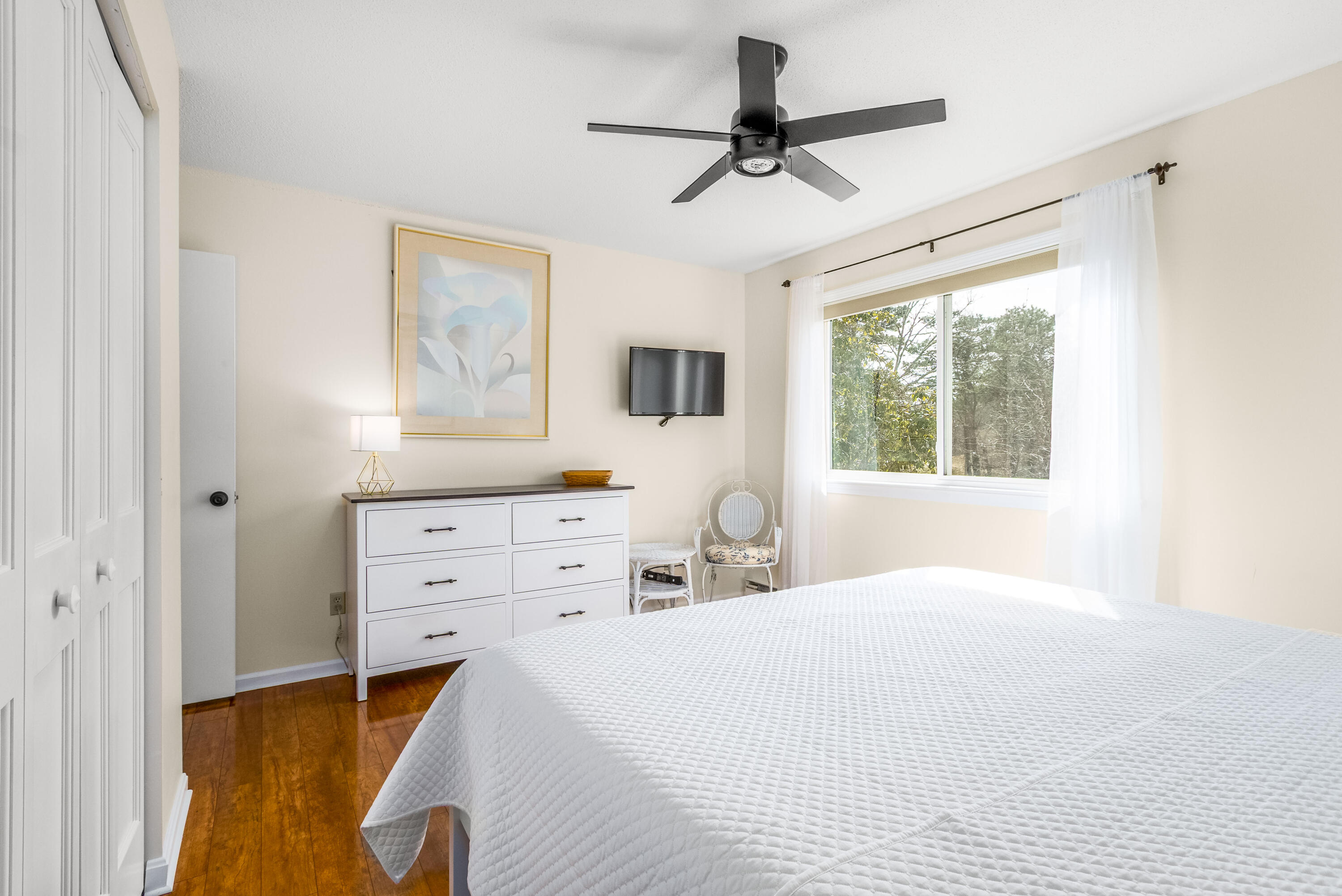 48 Middlecott Lane, Unit 48 Brewster, MA 02631 - Photo 11 of 36 a bedroom with a bed and a flat tv screen on dresser