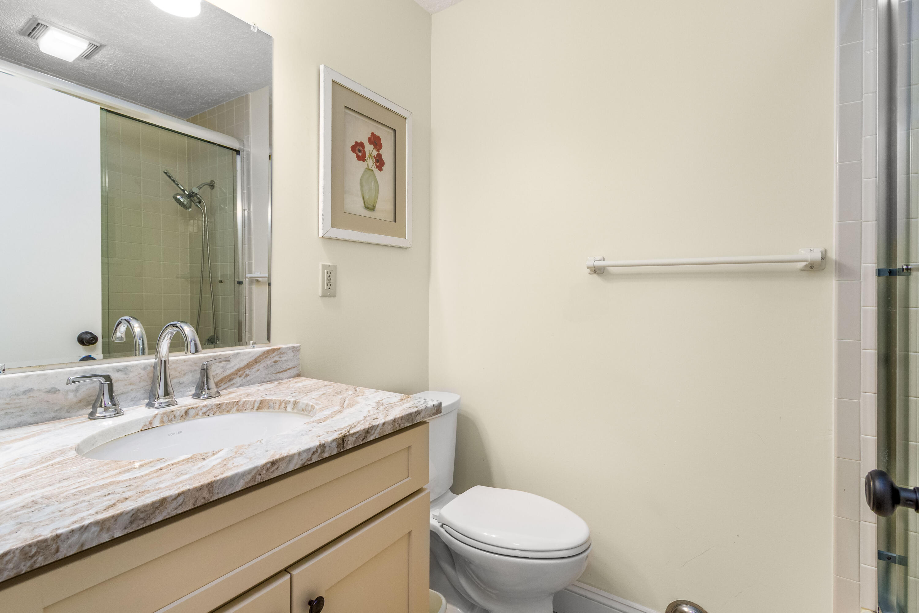 48 Middlecott Lane, Unit 48 Brewster, MA 02631 - Photo 15 of 36 a bathroom with a granite countertop sink toilet and a mirror