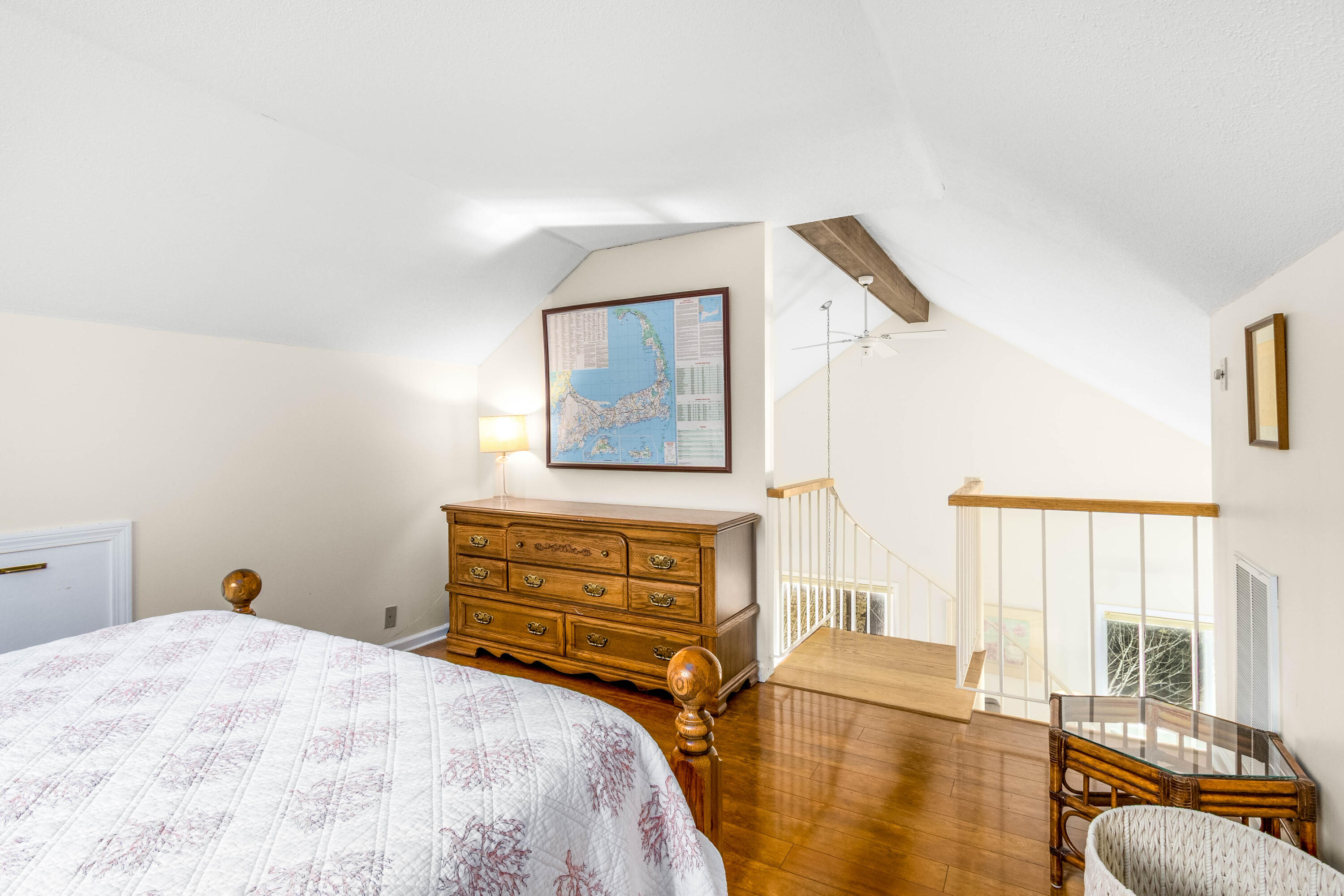48 Middlecott Lane, Unit 48 Brewster, MA 02631 - Photo 18 of 36 a bedroom with a bed and wooden floor
