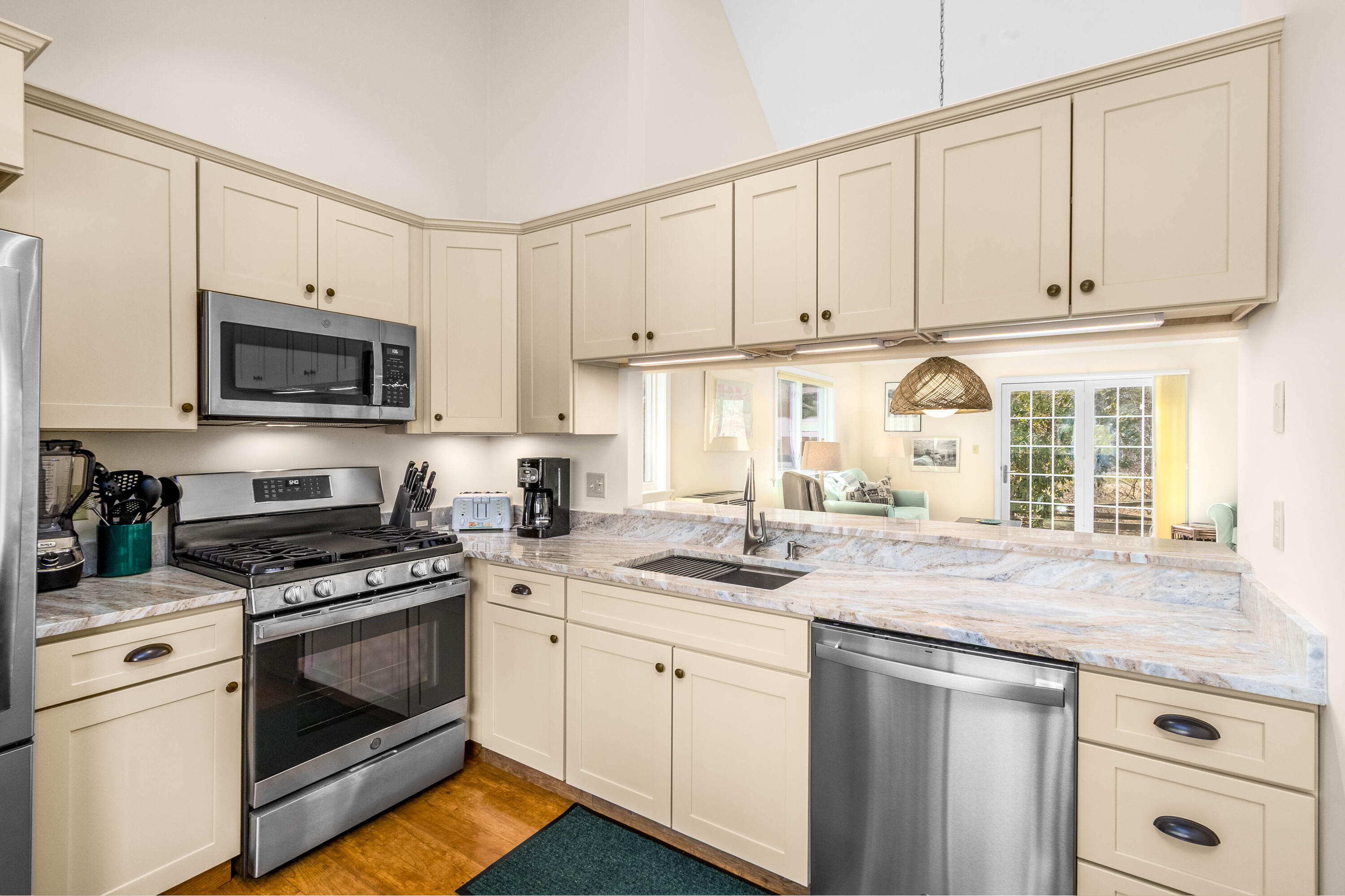 48 Middlecott Lane, Unit 48 Brewster, MA 02631 - Photo 3 of 36 a kitchen with granite countertop white cabinets white stainless steel appliances and a sink