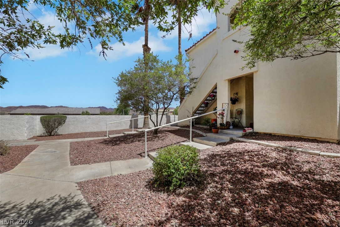 698 South Racetrack Road, Unit 1614 Henderson, NV 89015 - Photo 7 of 35 A desert-friendly landscape surrounds this welcoming building, offering direct outdoor access.