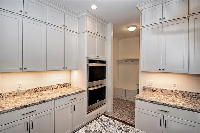 a kitchen with granite countertop cabinets and oven