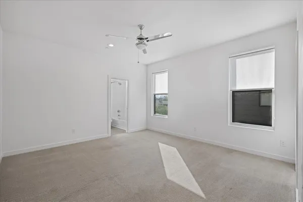a view of an empty room with a ceiling fan