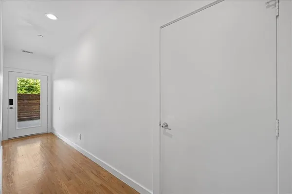 a view of room with window and hardwood floor