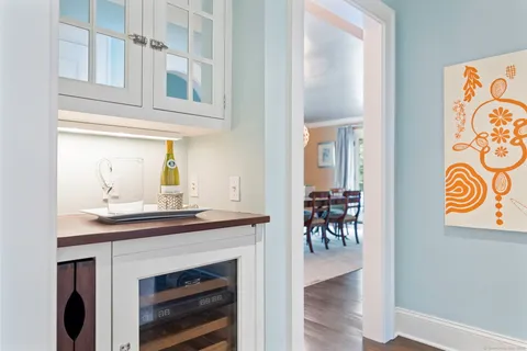 a view of a hallway with wooden floor and a fireplace