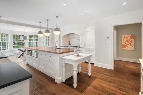 a large white kitchen with a large window