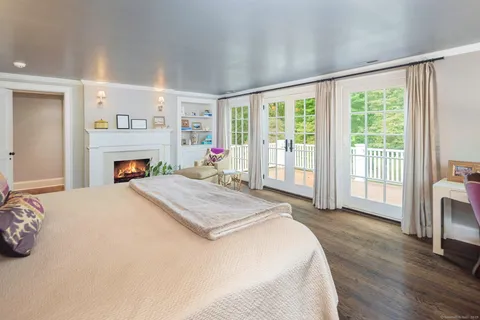 a spacious bedroom with a large bed and a fireplace