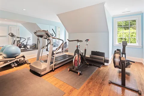 a bedroom with furniture and a wooden floor