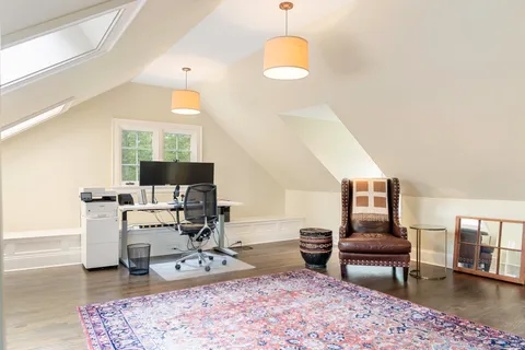 a view of a house with sitting area and floor to ceiling windows