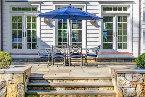 a view of a chairs and table in backyard