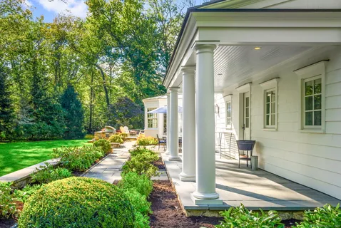 a view of a house with a yard and sitting area