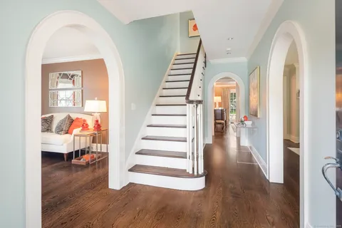 a view of entryway and hall with wooden floor