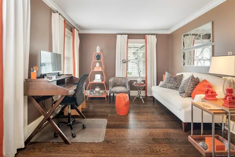 a living room with furniture and wooden floor