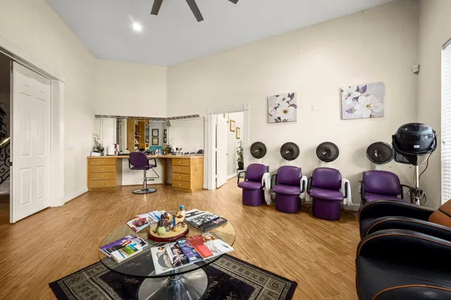 a living room with furniture a large window and a flat screen tv